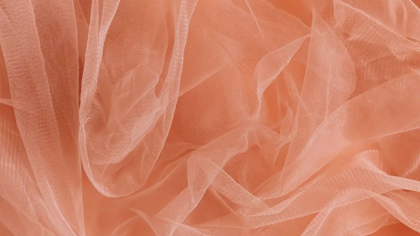Soft peach Power Mesh fabric displays its delicate, breathable weave—perfect for lightweight garments, activewear and stylish layering designs